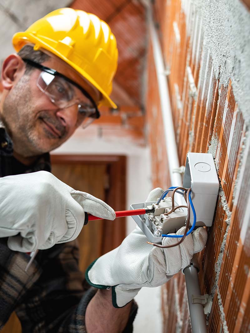 Electrician installing an electrical box