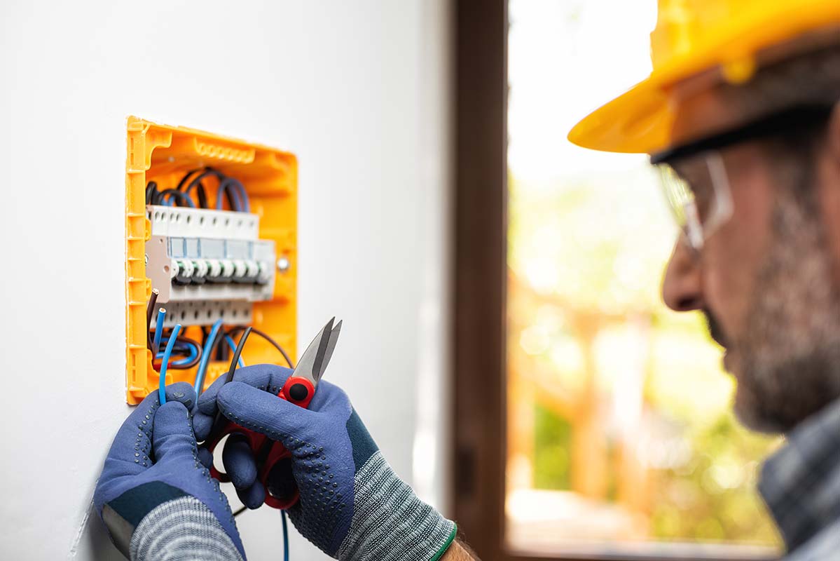Electrician installing an electrical box
