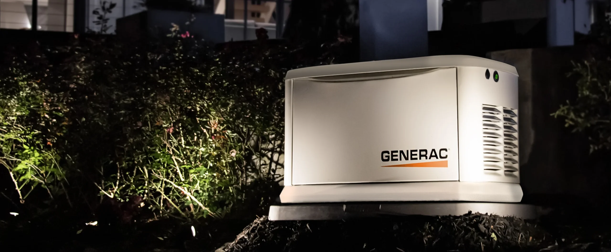 Generac generator outside of a home at night